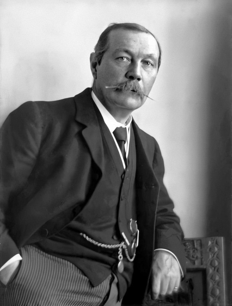 A black and white photograph of Sir Arhtur Conan Doyle by Walter Benington, taken in 1914