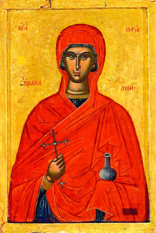 An icon of Mary Magdalene, Myrrhbearer. Robed in red with blue garments barely visible beneath, she faces the viewer with a cross in her right hand and a vase of incense in her left hand.